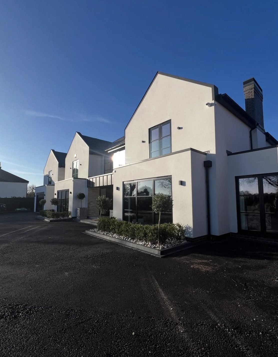 Row of new-build houses in off-white render